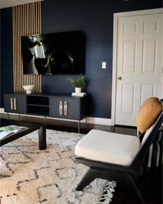 a living room with blue walls and white carpet