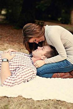 a man and woman laying on top of each other