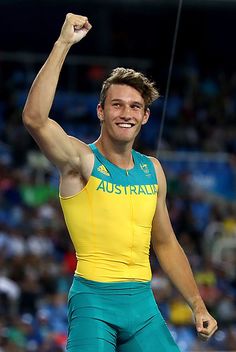 a male athlete is celebrating his gold medal