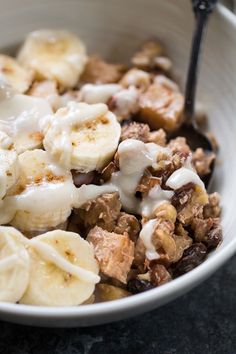 a white bowl filled with cereal and bananas