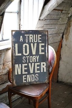 a true love story never ends sign on a chair