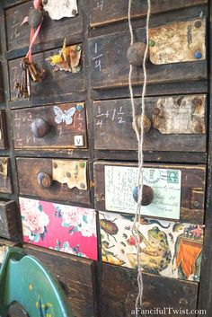 an old wooden cabinet with lots of magnets and tags on the door knobs