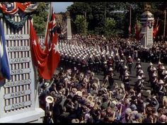 a large group of people in uniform marching down the street