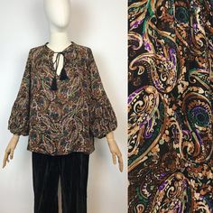 "Bohemian paisley printed blouse  Made in Italy  Brand: Aroma Approx. size: M Material: 100% viscose  In great condition! Measurements: Shoulders: 38 cm - 14,9\" Width armpit to armpit: 70 cm - 27,5\" Sleeve length: 47 cm - 18,5\" Front length: 60 cm - 23,6\" Back length: 68 cm - 26,7\" Any questions - please ask! :)" Patterned Long Sleeve Boho Print Blouse, Bohemian Blouse With Vintage Print For Fall, Bohemian Patterned Rayon Blouse, Flowy Patterned Blouse With Boho Print, Flowy Boho Print Patterned Blouse, Bohemian Printed Viscose Blouse, Patterned Boho Print Long Sleeve Peasant Top, Patterned Long Sleeve Peasant Top With Boho Print, Bohemian Patterned Tops With Paisley Print