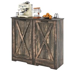 an old wooden cabinet with two doors and a coffee maker on top, next to some oranges