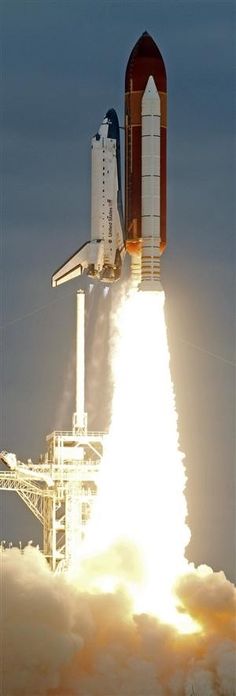 the space shuttle lifts off into the sky