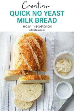 a loaf of bread sitting on top of a white towel next to butter and a knife