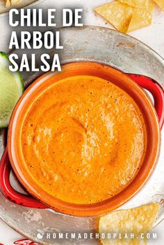 a bowl of salsa with tortilla chips on the side and text overlay reads chile de arbol salsa