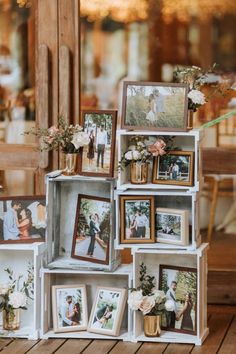 an arrangement of pictures and flowers on display