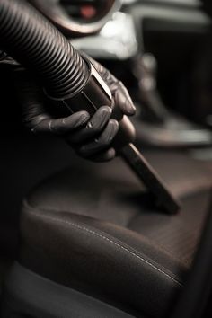 a close up of a person's hand holding a car vacuum