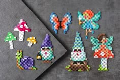 the pixel art project is being made with different colored beads and plastic pegs to make it look like they are from fairy land