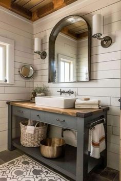 a bathroom with a sink, mirror and rug