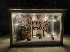 a lighted display case with christmas decorations on it