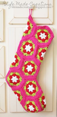 a crocheted christmas stocking hanging on a door