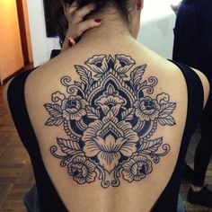 a woman with a black and white tattoo on her back