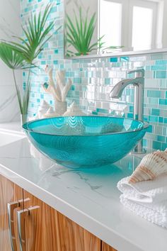 a glass bowl sink sitting on top of a white counter