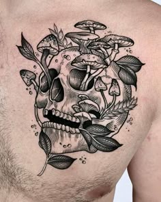 a skull with leaves and mushrooms on his chest