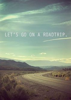 an empty road with the words let's go on a roadtrip