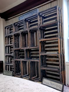 an old wooden crate sitting on top of a white rug in front of a window