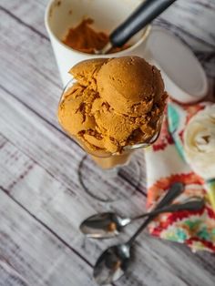 two scoops of ice cream and spoon on a table