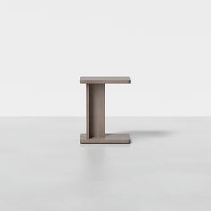 a small square table sitting on top of a white floor