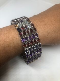 This genuine bright red Garnets, amethysts, iolites, citrines Aquamarines bracelet is very lively and bright. The stones are deep colors natural stones The sterling silver is plated with rhodium to protect the bracelet from tarnish 7.5 in About an inch wide All jewelry is shipped free in the US in a nice gift box. Check out our over a THOUSAND great reviews Engraving is $4 per letter and is not always perfect depending on the piece. It can take a few days if the jeweler is busy. This is payable Sterling Silver Multicolor Stone Bracelets, Multicolor Sterling Silver Bracelets With Stones, Luxury Multicolor Amethyst Gemstones, Elegant Multicolor Sterling Silver Bracelet With Stones, Amethyst Multi-stone Bracelet Gift, Elegant Multicolor Stones Sterling Silver Bracelet, Multicolor Sterling Silver Bracelet With Stones, Multicolor Gemstone Sterling Silver Bracelets, Multicolor Amethyst Bracelets With Natural Stones