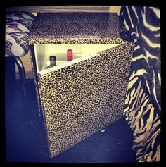 an animal print box with bottles in it