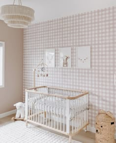 a baby's room decorated in pink and white