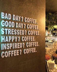 there is a sign on the wall that says bad day? coffee, good day? coffee stressed? coffee happy? coffee inspired? coffee inspired? coffee