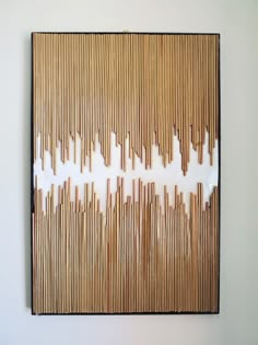 a painting made out of bamboo sticks on a wall