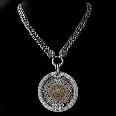 "This piece features my huge 3\" (76mm) antique silver finish Aztec Calendar Stone design medallion with an antique bronze centerpiece on a double-strand antique braided chain with eagle wings ends. It will catch every eye within 50 feet and be the source of many conversations. The look and feel of our necklace upon the first touch will speak to you immediately of hand-crafted quality. It makes a stunning accessory - appropriate for all ages, men or women - all will love it. It includes a black Luxury Silver Medallion Necklace, Luxury Silver Engraved Medallion Necklace, Luxury Engraved Silver Medallion Necklace, Antique Silver Medallion Jewelry With Antique Finish, Bronze Metal Medallion Necklace, Bronze Centerpiece, Aztec Jewelry, Love Warriors, Aztec Calendar