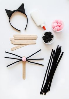 the craft kit is made with popsicle sticks, cat ears, and other items