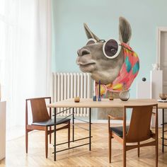 a giraffe with sunglasses on it's head sitting at a table