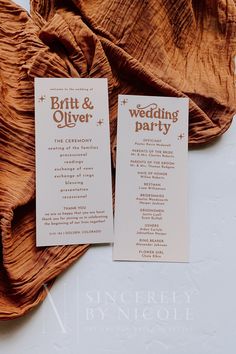 two wedding program cards on top of a brown cloth draped over the back of a chair