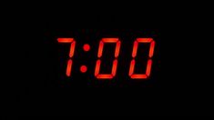 the digital clock is red in the dark