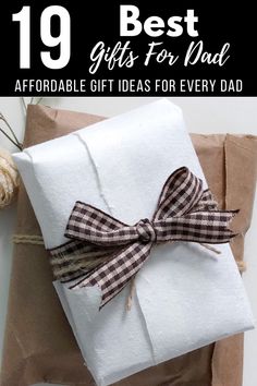 the best gifts for dad on father's day are wrapped in brown paper and tied with twine