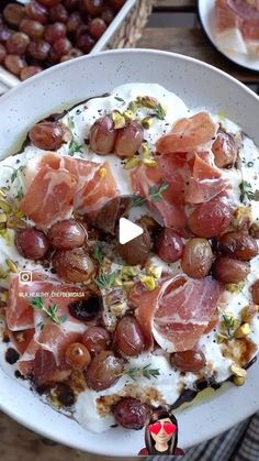 a white plate topped with lots of food on top of a wooden table next to other plates