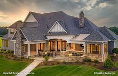 an aerial view of a large house at sunset