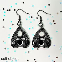 pair of earrings with the words goodbye and goodbye written on them, hanging from stars