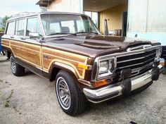 an old station wagon parked in front of a building