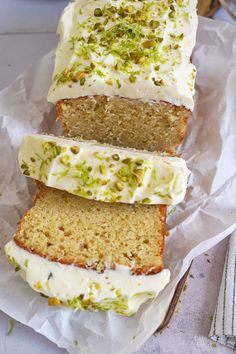 three slices of cake with white frosting and pistachio sprinkles