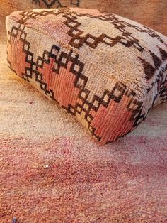 an old rug is laying on the floor with it's end up to its side