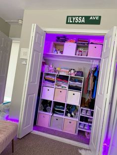 the closet is filled with lots of items and has purple lights on it's doors