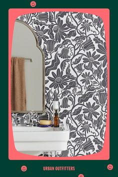 an image of a bathroom setting with floral wallpaper and pink border around the sink