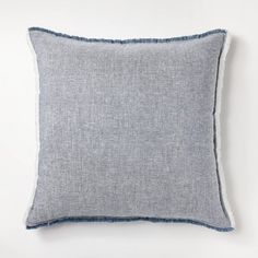 a blue and white pillow with fray edges