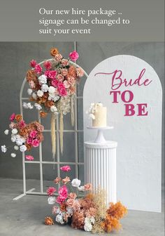 a wedding cake sitting on top of a table next to a white vase filled with flowers