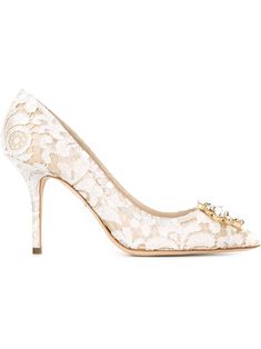 Dolce and Gabbana live and breathe Italian spirit - reflected within their collection of sleek ready-to-wear and accessories that redefine Sicilian seductiveness. These off-white Belluci Taormina lace pumps feature a pointed toe, a floral lace pattern, crystal embellishments, a brand embossed insole and a high stiletto heel. White Lace Shoes, White Stilettos, Floral Pumps, Designer Wedding Shoes, Trendy Heels, Lace Pumps, White Leather Shoes, Heels White, Dolce Gabbana Shoes