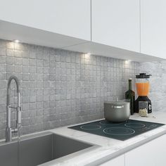 a kitchen counter with a blender on it and a sink in front of it