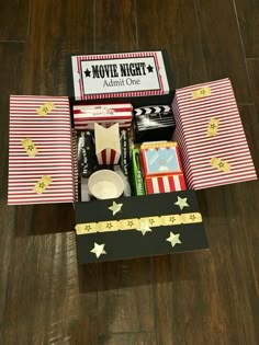 the movie night gift box is packed with popcorn, movies and other things to make it memorable