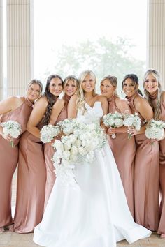 the bride and her bridesmaids pose for a photo